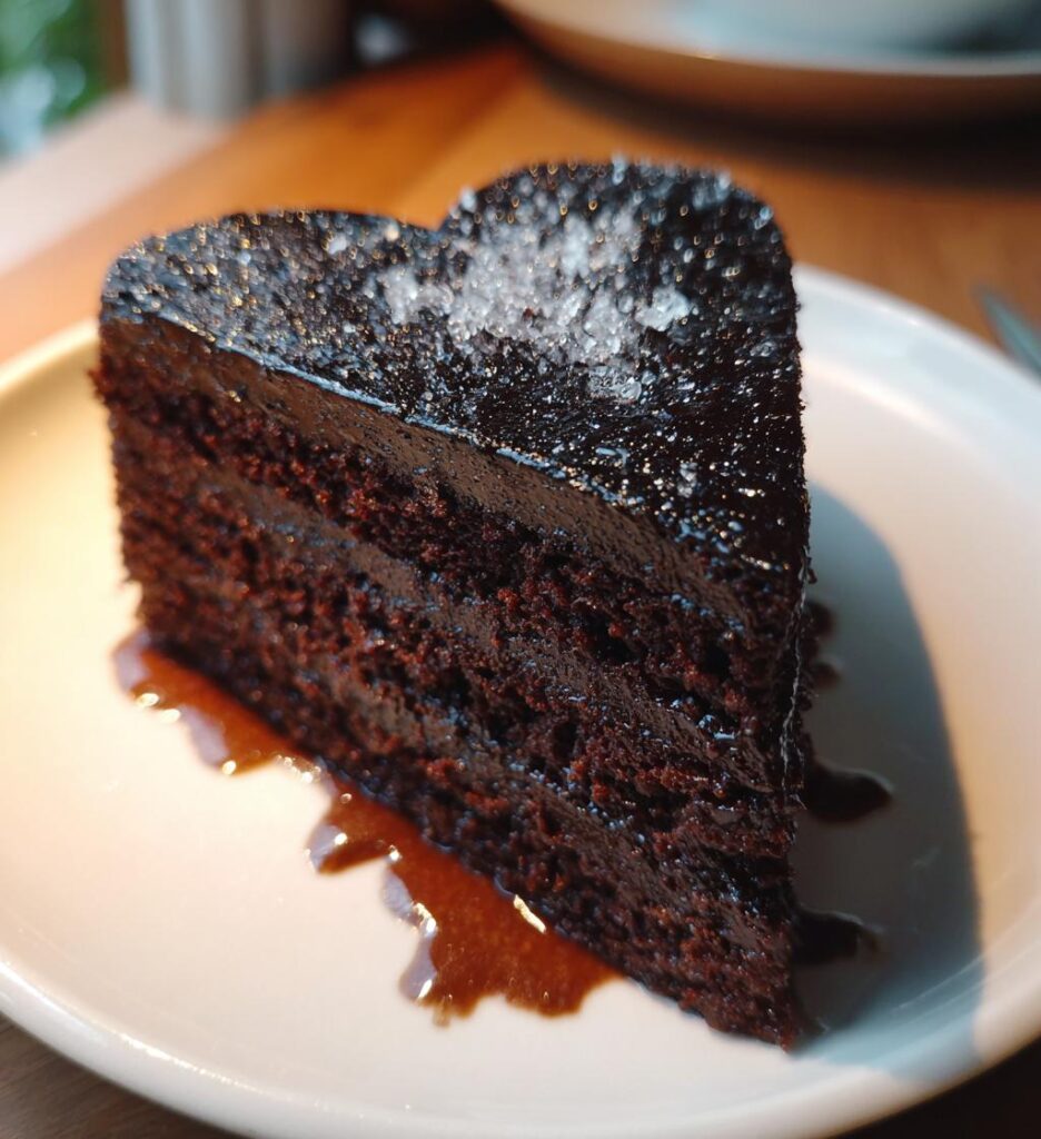 black heart shaped cake with glitter